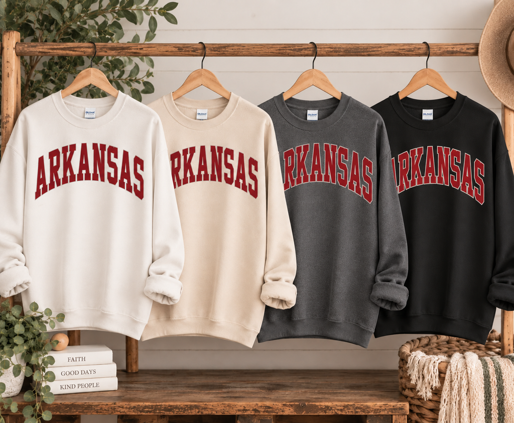 Arkansas sweatshirts in white, cream, charcoal, and black hanging together