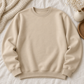 Blank sand-colored Gildan crewneck sweatshirt on an ivory boutique background