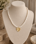 Pearl Heart Necklace with ivory pearl-style beads and a textured gold-tone heart pendant