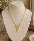 The Sunday Charm Necklace with a gold paperclip chain, sparkling cross and heart pendant