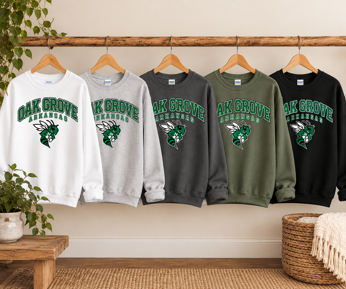 Vintage Oak Grove Arkansas sweatshirts in White, Ash, Charcoal, Military Green, and Black hanging on a wooden rail